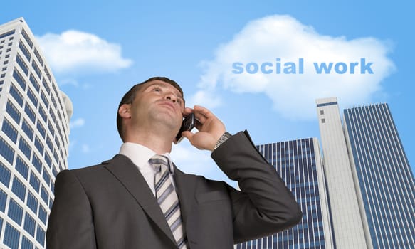 Businessman talking on the phone. Skyscrapers and cloud with words social work in background