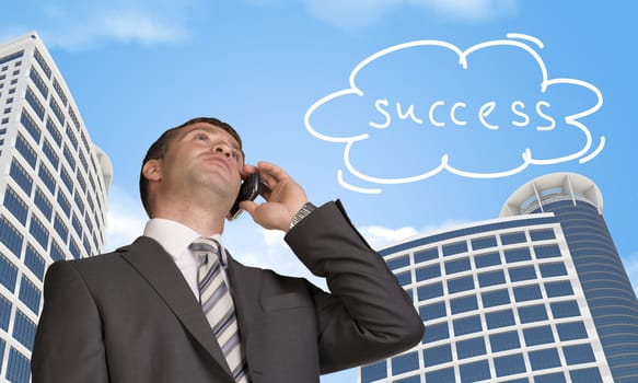 Businessman talking on the phone. Skyscrapers and cloud with word success in background