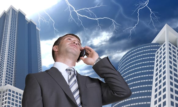 Businessman talking on the phone. Skyscrapers and lightning in background