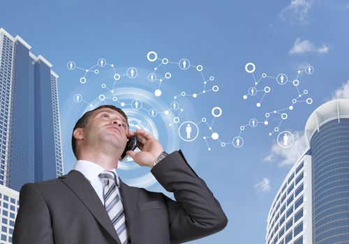 Businessman talking on the phone. Skyscrapers and sky with network in background