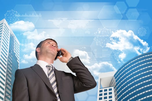 Businessman talking on the phone. Skyscrapers and sky with business elements in background