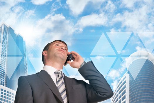 Businessman talking on the phone. Skyscrapers and sky with transparent triangles in background