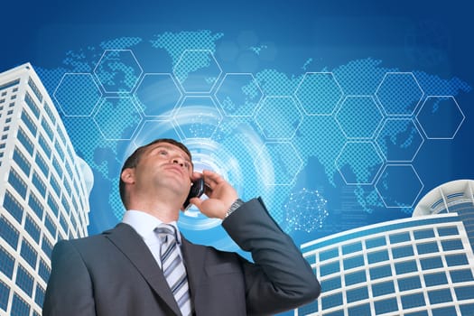 Businessman talking on the phone. Skyscrapers, sky and hexagons with world map in background
