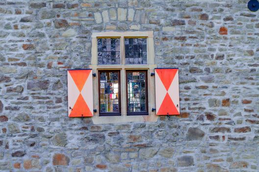 Historic window of a castle with stained glass
