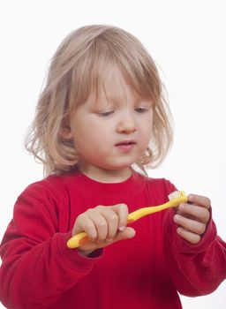 boy with long blond hair and toothbrush - isolated on white