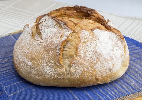 Freshly baked homemade bread dusted with flour 
