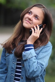 Happy and beautiful girl talking on the phone