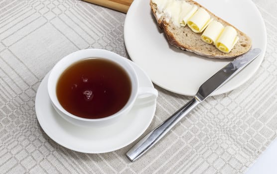 cup of black tea with a sandwich for breakfast
