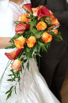 Beautiful wedding bouquet in hands of the bride