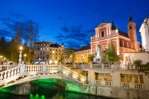 Romantic Ljubljana's city center at dusk. River Ljubljanica, Triple Bridge, Preseren square and Franciscan Church of the Annunciation. Ljubljana, Slovenia, Europe. 