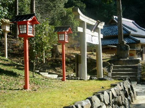 Japanese traditional gate and red lanterns at temple entrance, Okayama