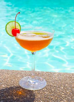 Cocktails near the swimming pool on summer .