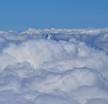 Peak of a 4000m Swiss mountain visable through the clouds