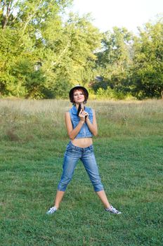 The girl in a hat with a pistol