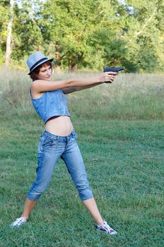 The girl in a hat with a pistol