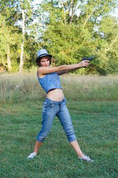 The girl in a hat with a pistol