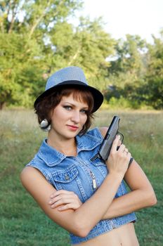 The girl in a hat with a pistol