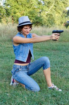 The girl in a hat with a pistol