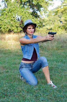 The girl in a hat with a pistol