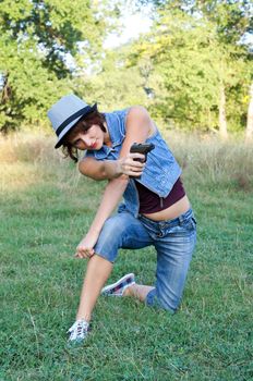 The girl in a hat with a pistol