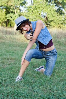 The girl in a hat with a pistol