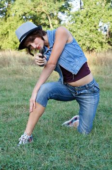 The girl in a hat with a pistol