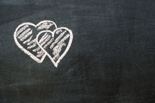 hand-drawn hearts symbols on the blackboard with blank space on left