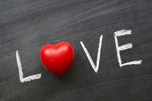 love word handwritten on blackboard with red heart instead of o