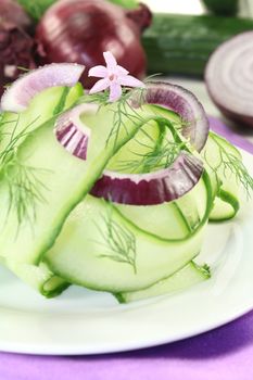 Cucumber salad with red onions, garlic flower and dill