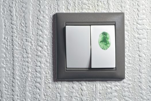 two keys light switch, one is touched by green color fingertip to switch "green" ecological energy