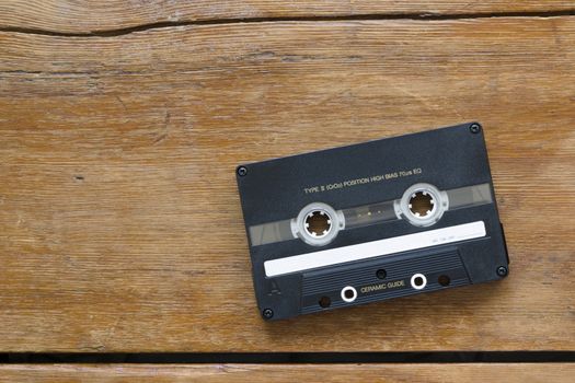 vintage hi-end audio cassette on cracked wooden table