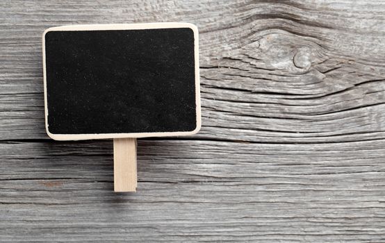 Vintage slate chalk board hanging on wooden background