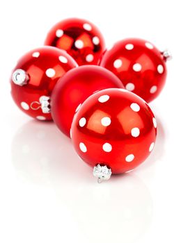 red polka dot Christmas bauble, isolated over white