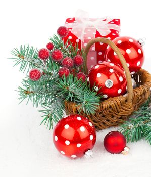 Christmas balls and fir branches with decorations isolated over white