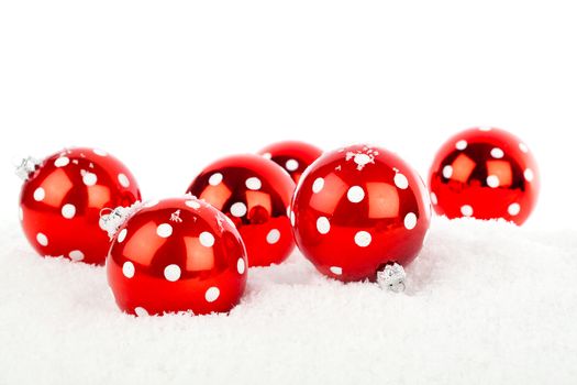 red polka dot Christmas bauble, isolated over white