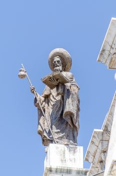 Statue of monk on top of building in Spain