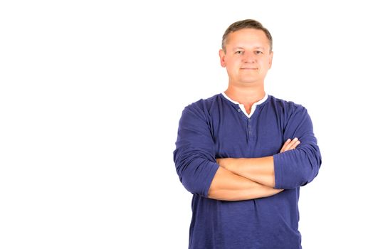 Casually dressed middle aged man with arms folded. 3/4 view of man shot in horizontal format isolated on white.