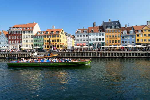 COPENHAGEN, DENMARK - MAY 18: unidentified people in open cafes of the famous Nyhavn promenade on May 18, 2013 in Copenhagen, Denmark. Nyhavn is one of the most famous landmark of Copenhagen.