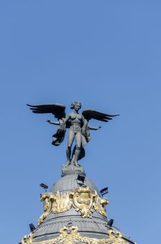 Statue of winged women on top of building in Spain