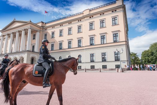 OSLO, NORWAY - AUGUST 28: Mounted Police near Oslo Royal Palace at August 28, 2014. Rytterkorpset (The Mounted Police) established at 1893. At present 15 horses and around 25 officers.