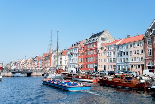 COPENHAGEN, DENMARK - MAY 18: unidentified people in open cafes of the famous Nyhavn promenade on May 18, 2013 in Copenhagen, Denmark. Nyhavn is one of the most famous landmark of Copenhagen.