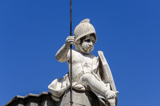 Statue of a boy on top of building in Spain