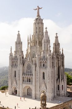 Tibidabo church on mountain in Barcelona with christ statue overviewing the city