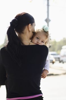 Mother is in the hands of a child in a crowded place