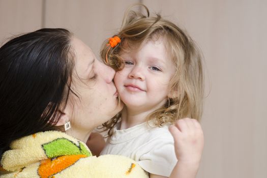 Mom keeps on handles two year-old daughter who just woke up. Closeup