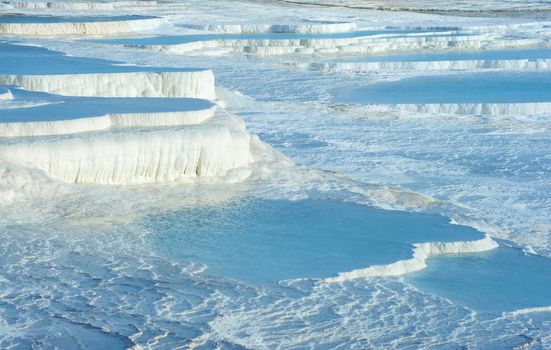 Blue pools and white travertine terraces at Pamukkale, Turkey 