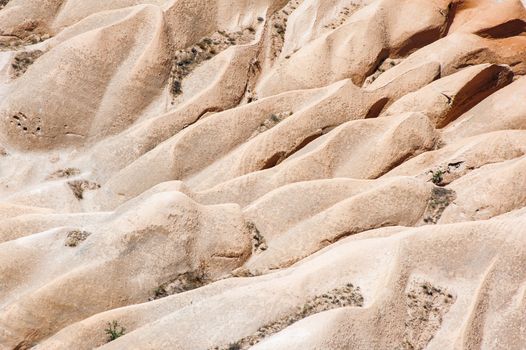 Detailed photo of vivid pink rock formations from above in Cappadocia, Turkey