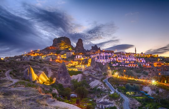 Ancient town and a castle of Uchisar dug from a mountains after twilight, Cappadocia, Turkey