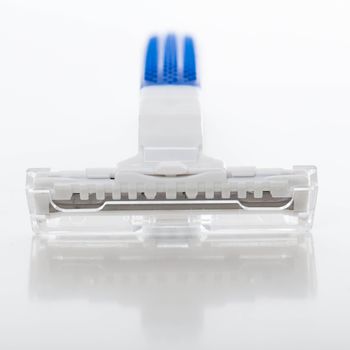 Picture of white and blue razor for men over a white background