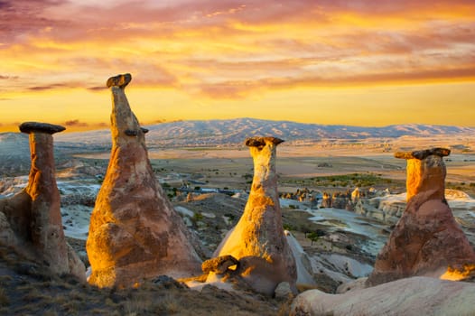 Rocks looking like mushrooms dramatically lit by a sunset in Cappadocia, Turkey